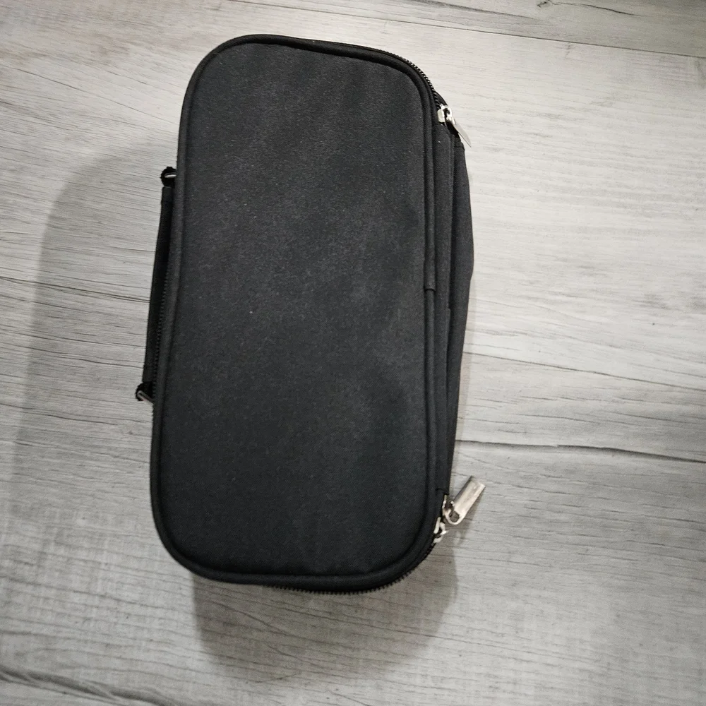 Torfly pencil case. Black with 2 zipper pouches and handle. Torly logo on front.